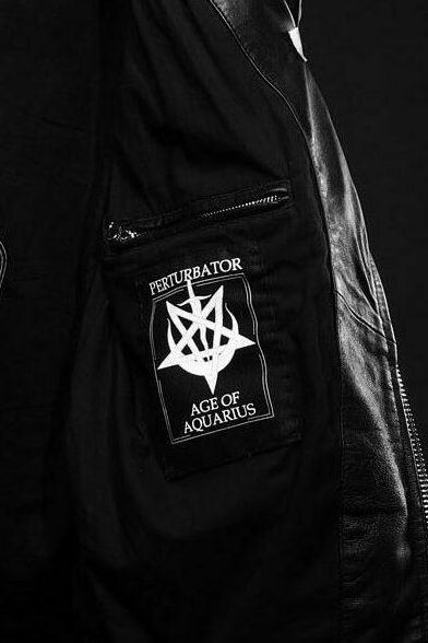 Custom Perturbator label revealing the album title Age of Aquarius inside the Schott Perfecto.